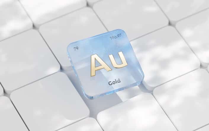 3D rendering of the gold (Au) element symbol on a keyboard, representing gold nanoparticle ink in printed electronics.